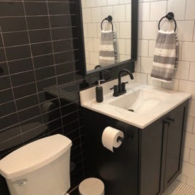 bathroom with dark tiles
